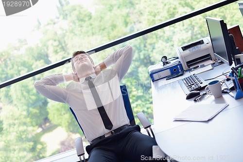 Image of happy young business man at office