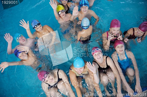 Image of happy children group  at swimming pool