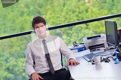Image of happy young business man at office