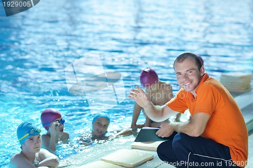 Image of happy children group  at swimming pool