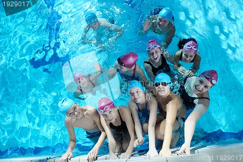 Image of happy children group  at swimming pool