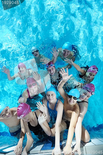 Image of happy children group  at swimming pool