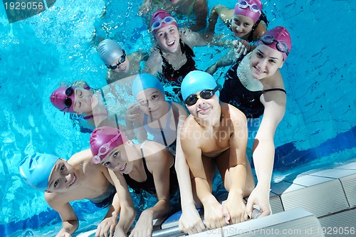 Image of happy children group  at swimming pool