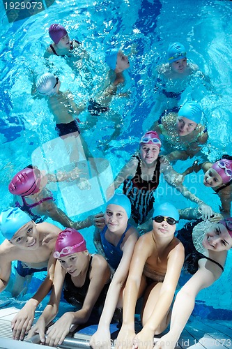 Image of happy children group  at swimming pool