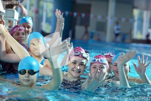 Image of happy children group  at swimming pool