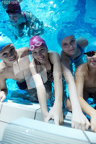 Image of happy children group  at swimming pool