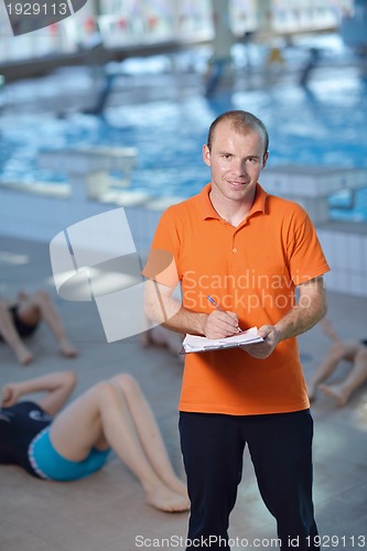 Image of happy children group  at swimming pool