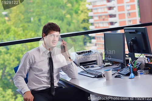 Image of happy young business man at office