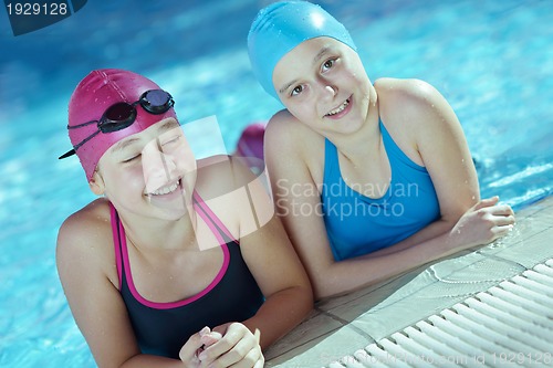 Image of happy children group  at swimming pool