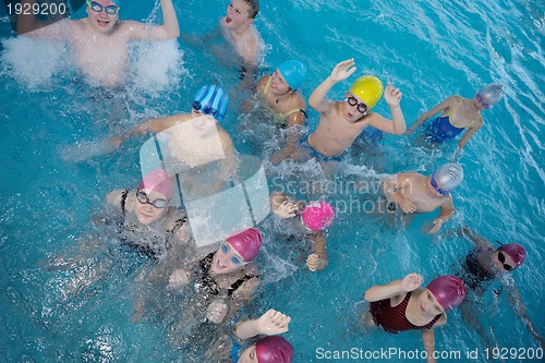 Image of happy children group  at swimming pool