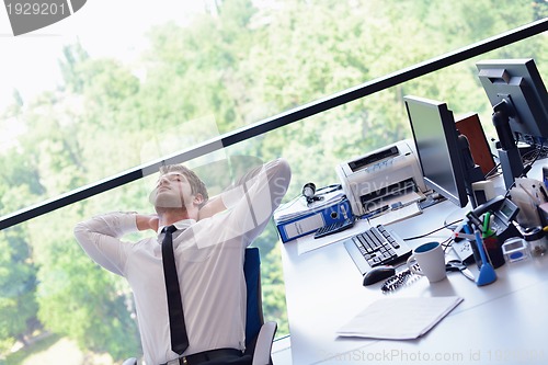 Image of happy young business man at office