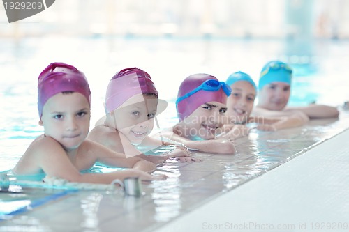 Image of happy children group  at swimming pool