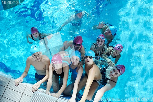 Image of happy children group  at swimming pool