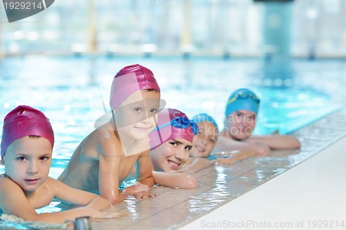 Image of happy children group  at swimming pool