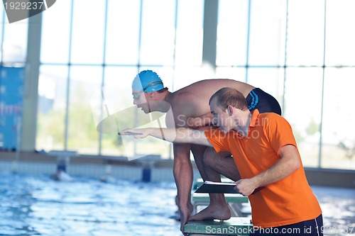 Image of swimmer practice jump with trainer