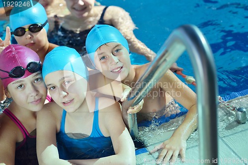 Image of happy children group  at swimming pool