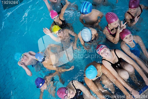 Image of happy children group  at swimming pool