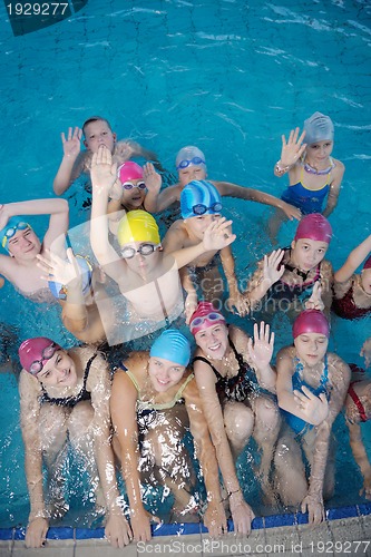 Image of happy children group  at swimming pool