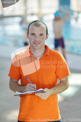 Image of happy children group  at swimming pool