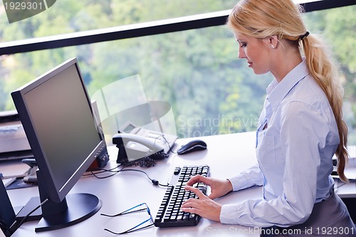 Image of business woman working on her desk in an office