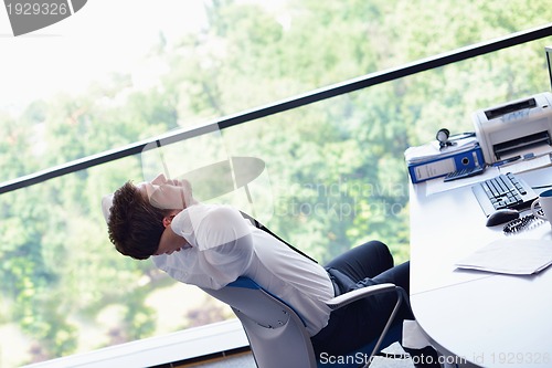 Image of happy young business man at office