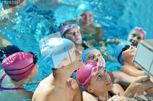 Image of happy children group  at swimming pool