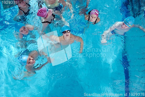 Image of happy children group  at swimming pool