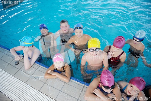Image of happy children group  at swimming pool