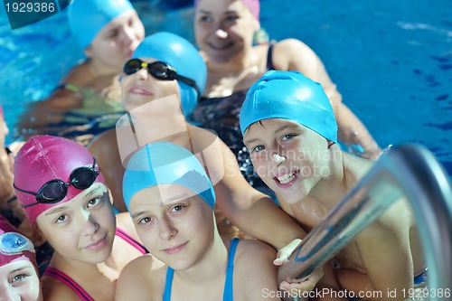 Image of happy children group  at swimming pool