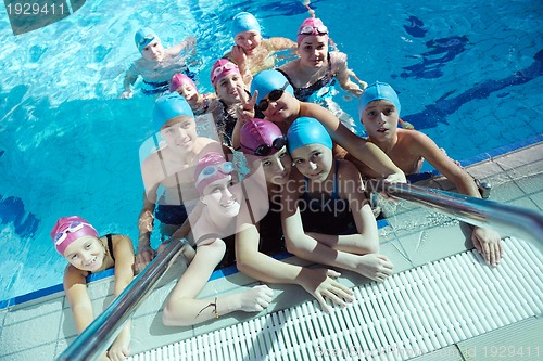 Image of happy children group  at swimming pool