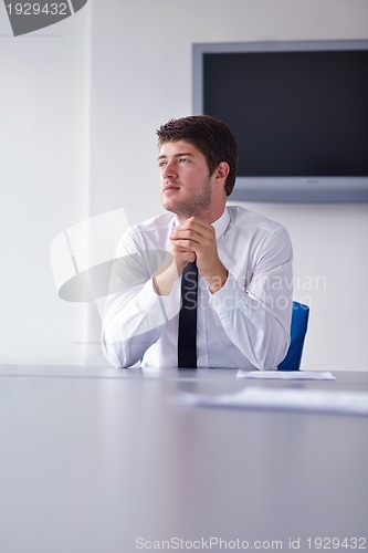 Image of happy young business man at office