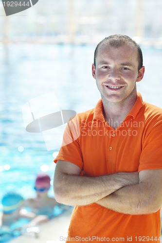 Image of happy children group  at swimming pool