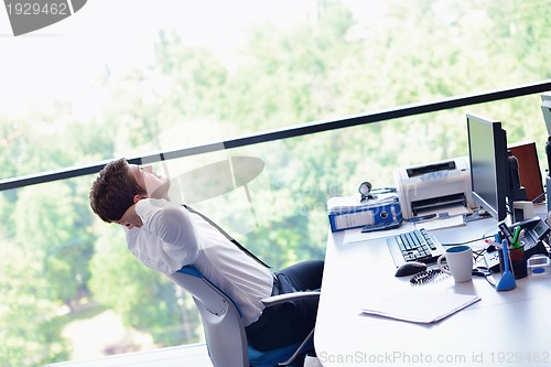 Image of happy young business man at office