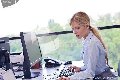 Image of business woman working on her desk in an office