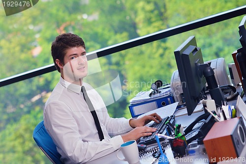 Image of happy young business man at office