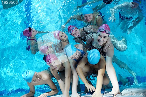 Image of happy children group  at swimming pool