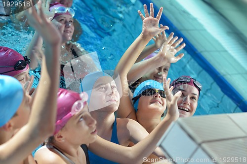 Image of happy children group  at swimming pool