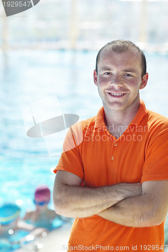 Image of happy children group  at swimming pool