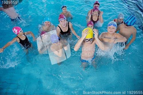 Image of happy children group  at swimming pool