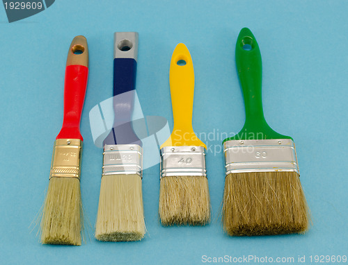 Image of paint brush color size on blue 
