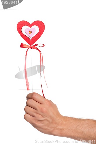 Image of Hand with heart on a stick