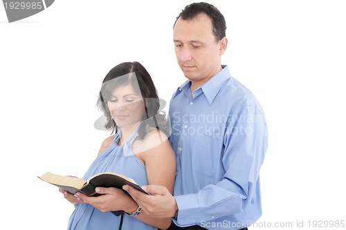 Image of Attractive couple reading the Bible 