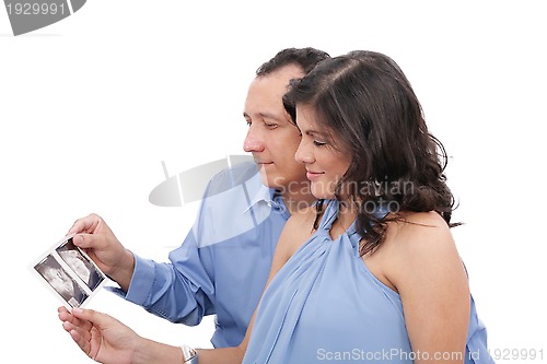 Image of Pregnant couple looking at an ultrasound 