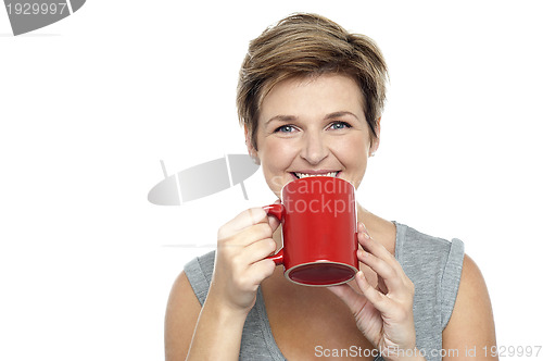 Image of Young woman enjoying her coffee