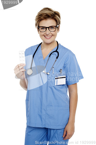 Image of Doctor at duty holding medicine pack in hand