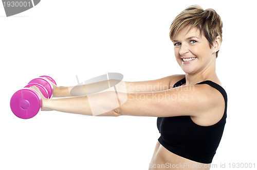 Image of Young beautiful woman with dumbbells in hands