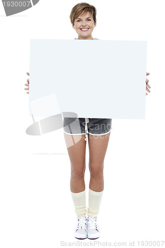 Image of Pretty woman presenting blank whiteboard