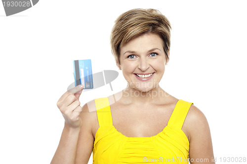 Image of Cheerful woman holding up her cash card