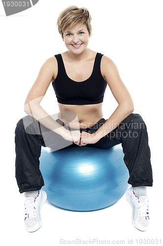 Image of Fitness woman relaxing on exercise ball