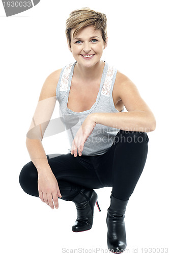 Image of Charming woman in squatting posture